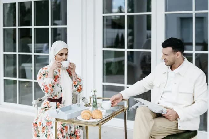 Muslim couple enjoying a serene breakfast outdoors in Saudi Arabia