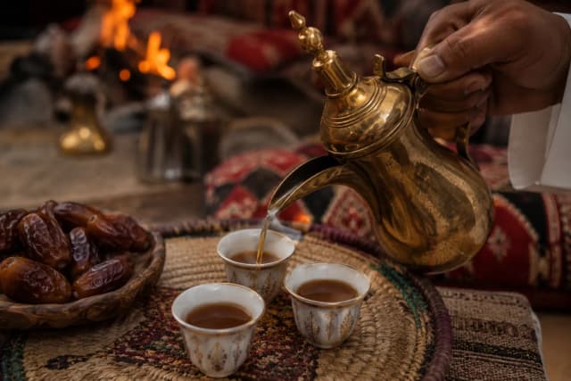 Traditional Saudi Arabic coffee served in small cups with dried figs