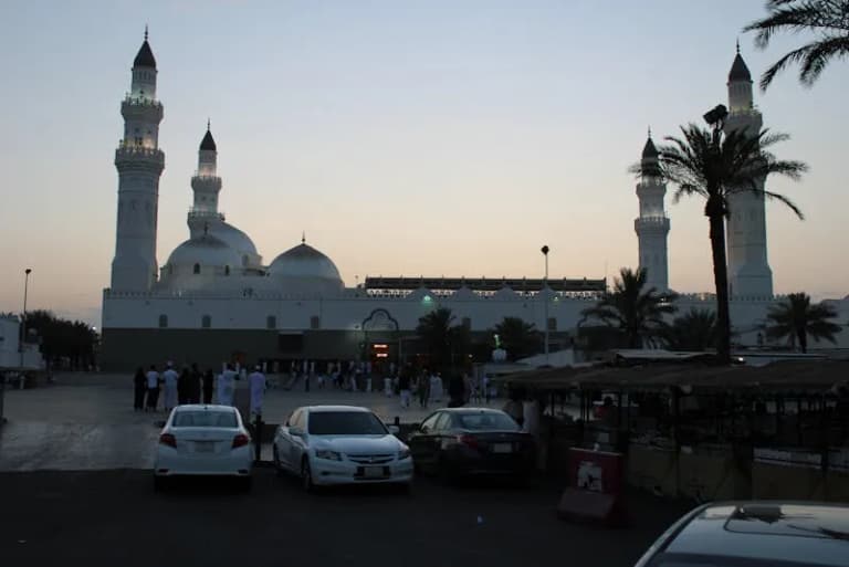 Quba Mosque at twilight with visitors gathering outside