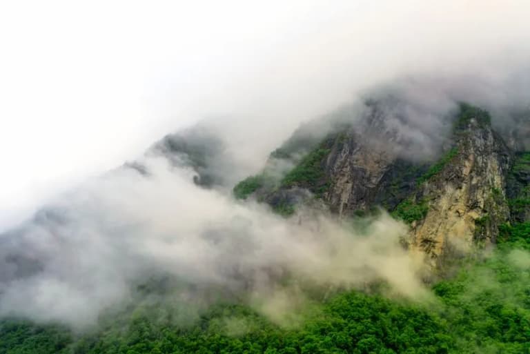 Misty green mountain peaks in the Asir region of Saudi Arabia